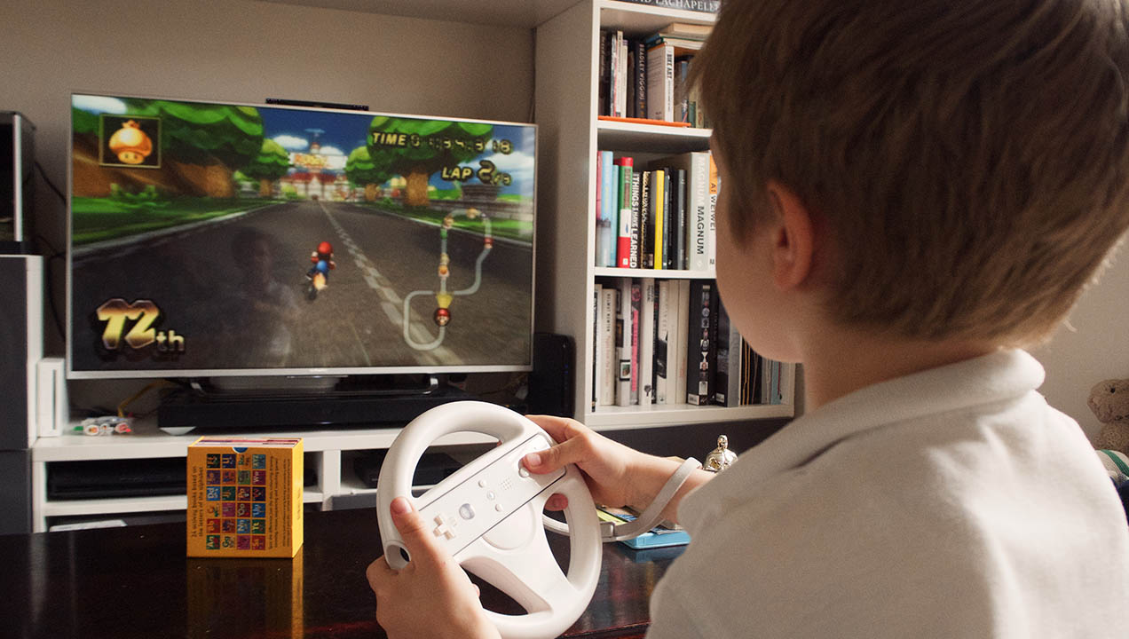 Child plays Wii racing game