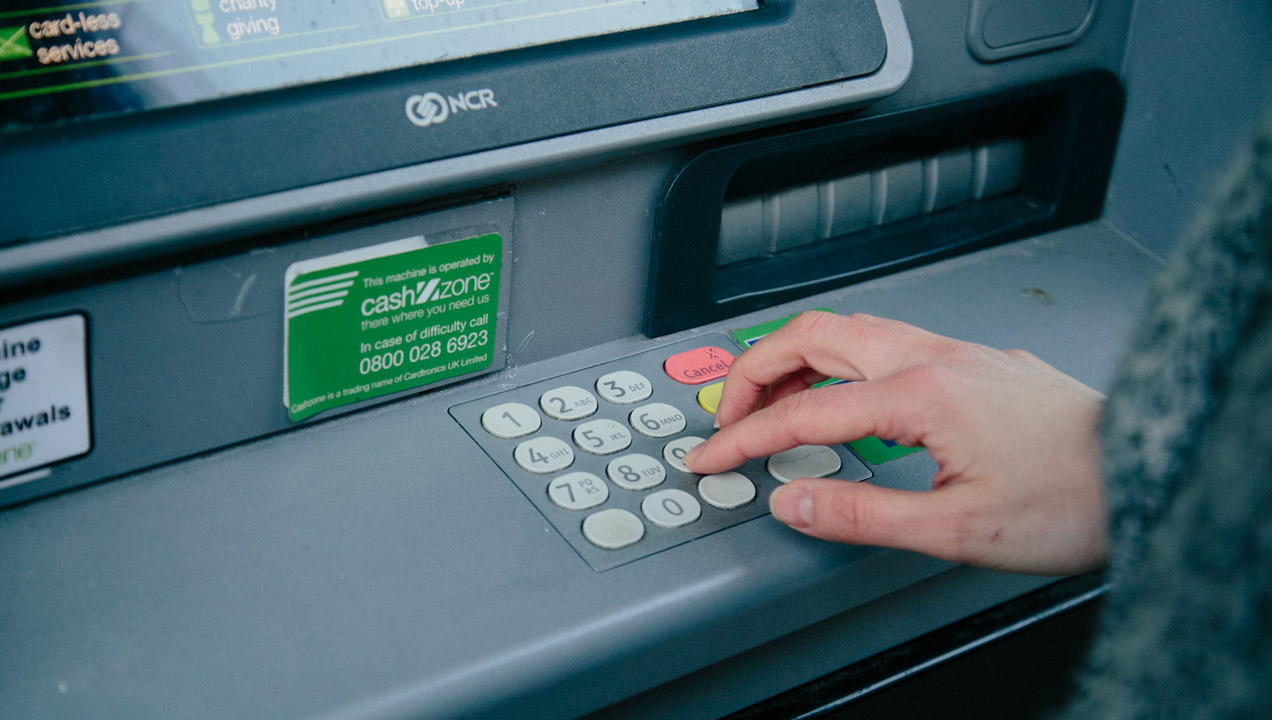 Keying in pin code to ATM