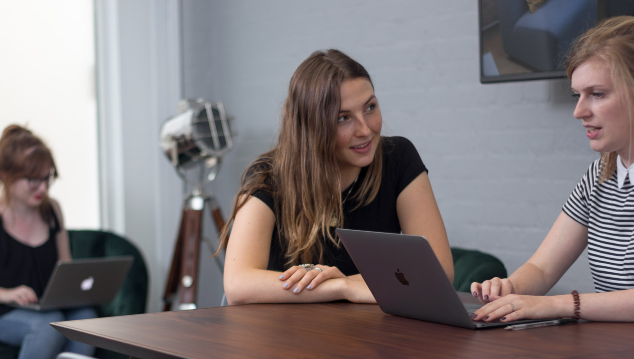 Sarah chatting with a colleague at our London studios