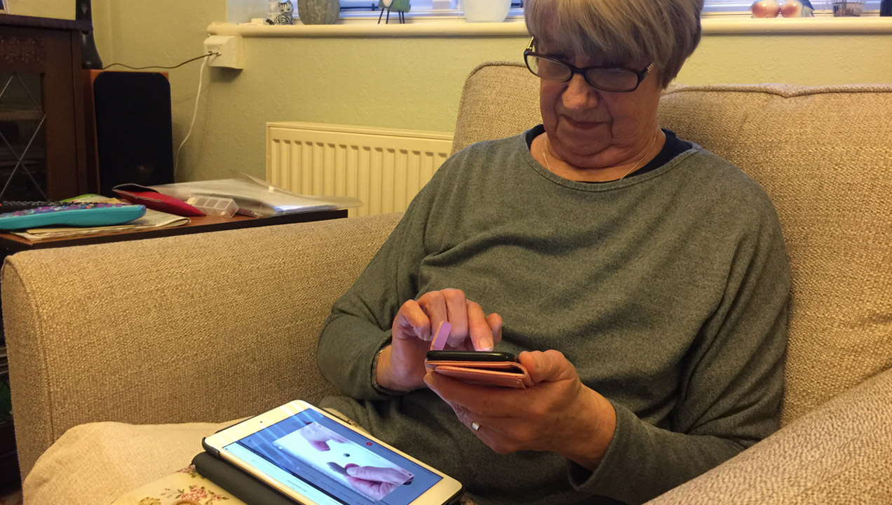 An older lady using an iPad