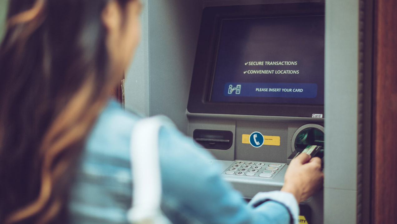 A woman using a ATM