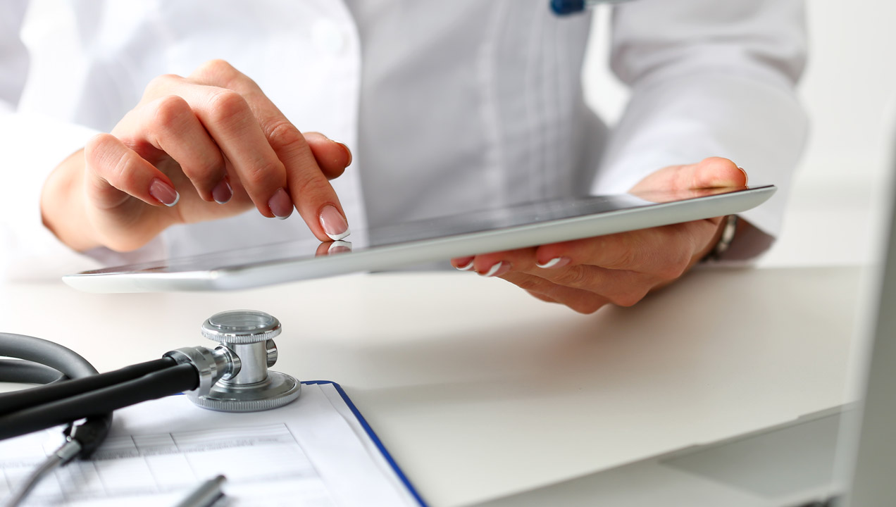 A doctor on an iPad