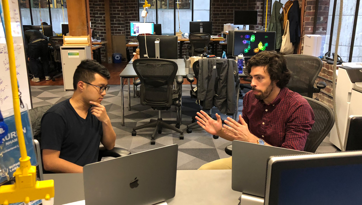 Jose in discussion with a colleague