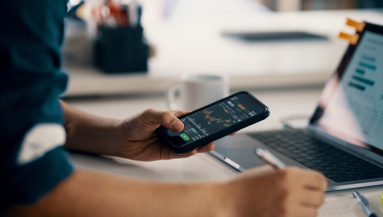 Man looking at financial information on mobile phone