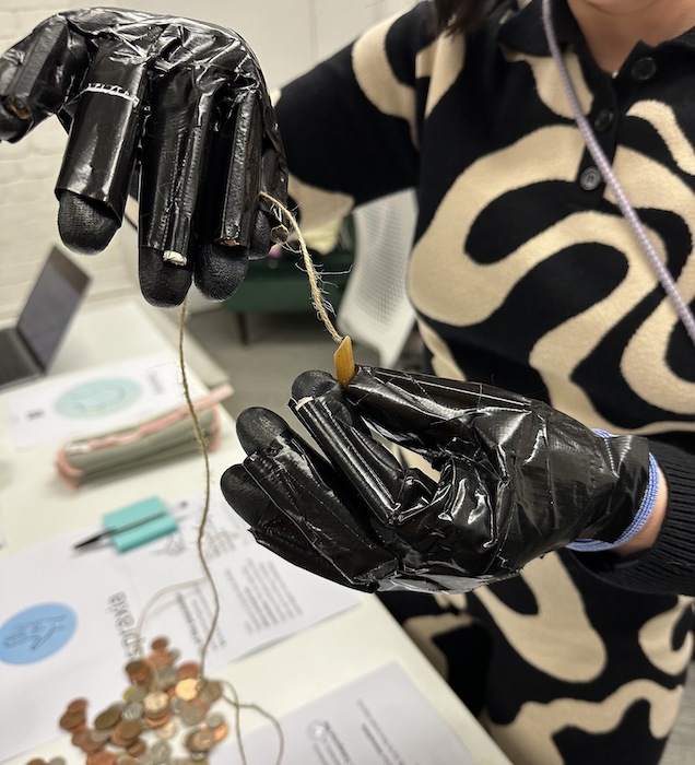 Woman wearing gloves as part of empathy workshop