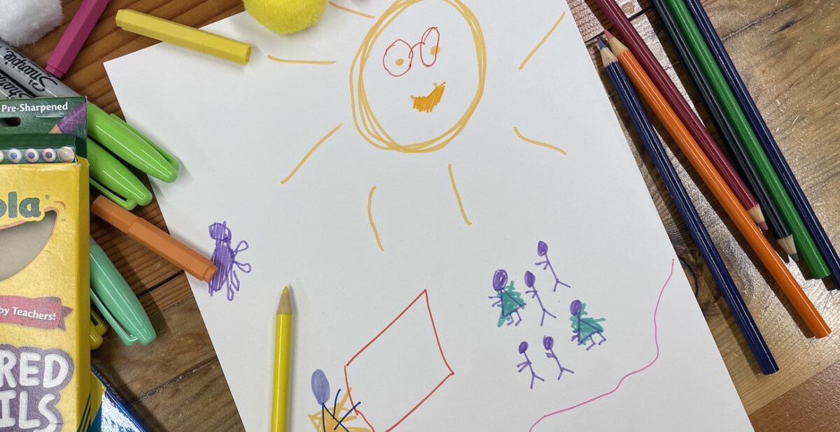 A child-like drawing on white A4 paper with pencil crayons and markers around the outside