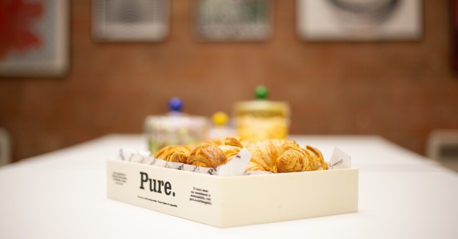 A picture of breakfast, croissants in a wooden box. 