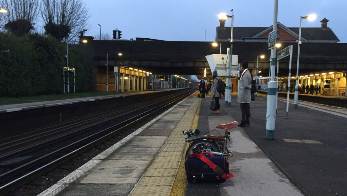 Brompton bike folded on a train platform in evening